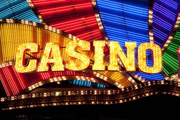 Dealer at roulette wheel with betting layout visible on table